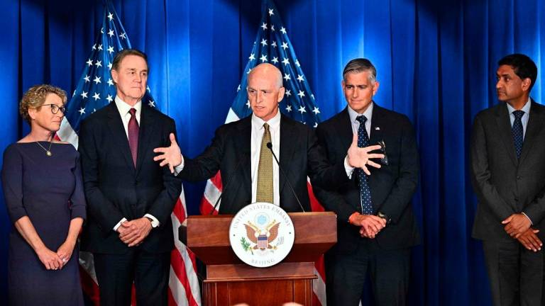 US Representative Adam Smith (C), Democratic ranking member of the House Armed Services Committee speaks flanked by (L-R) Chrissy Houlahan, Democratic member of House Armed Services Committee, David Perdue, US Ambassador to China, Michael Baumgartner, Republican member of House Foreign Affairs Committee and Ro Khanna, Democratic member of House Armed Services Committee during a press conference at the US embassy in Beijing on September 23, 2025. - Pedro Pardo / AFP