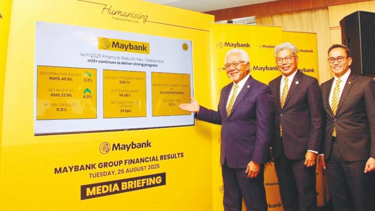 From left: Maybank chairman Tan Sri Zamzamzairani Mohd Isa, president and group CEO Datuk Seri Khairussaleh Ramli and group chief financial officer Shafiq Abdul Jabbar at a media briefing on the group’s financial results yesterday.
