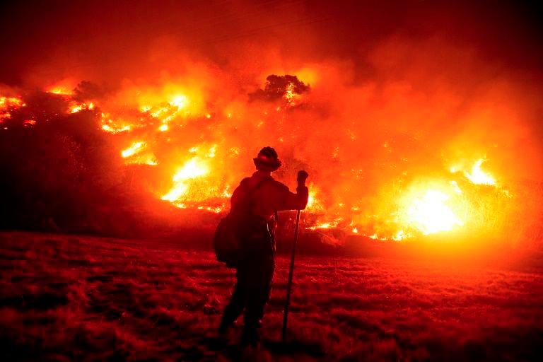 A firefighter works at the scene of the Bobcat Fire burning on hillsides near Monrovia Canyon Park in Monrovia, California on Sept 15, 2020 — AFP