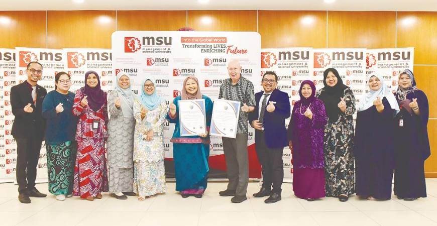 Centre, Prof Datin Dr. Norhisham Mohamad, MSU Vice President for Academic, receives the accreditation certificate from Professor David Hind, the APIEM President at the MSU main campus.