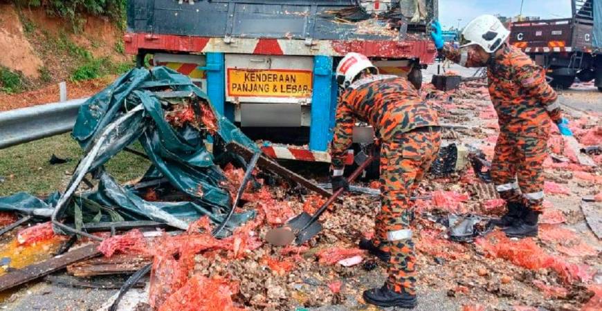 Fire and rescue personnel clearing the accident site. - Pic courtesy of Perak Fire and Rescue Department