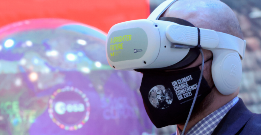 A delegate wears a VR headset at the media centre during COP26, Nov 2021. REUTERSpix