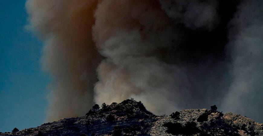 Smoke billowing from a forest fire near Pauls, next to Tarragona, in Spain’s Catalonia region. (Photo by JOSE JORDAN / AFP)