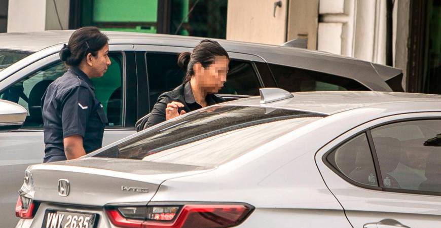 The woman being taken to be remanded in Ipoh yesterday. – BERNAMAPIC