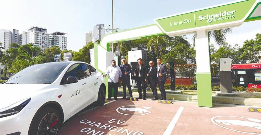 From feft: Bukit Gasing assemblyman Rajiv Rishyakaran, Quah, Wong, Tan and Schneider Electric Malaysia residential and general distribution VP vice-president Francis Heng at the site of the new EV charging station.