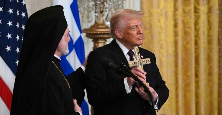 Trump displays a cross given to him by Elpidophoros of America (L), a bishop of the Ecumenical Patriarchate of Constantinople, during a Greek Independence Day celebration in the East Room of the White House in Washington, DC, AFPpix