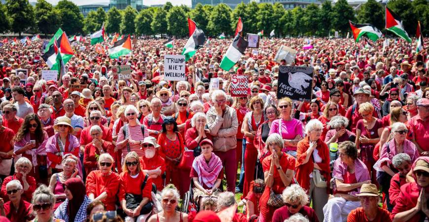 Protestors wave Palestinian flags and signs as they attend a demonstration called by Oxfam Novib, PAX, Amnesty International, Save the Children and Doctors Without Borders in support for the Palestinians, in The Hague on June 15, 2025. (Photo by ANP KOEN VAN WEEL / ANP / AFP)
