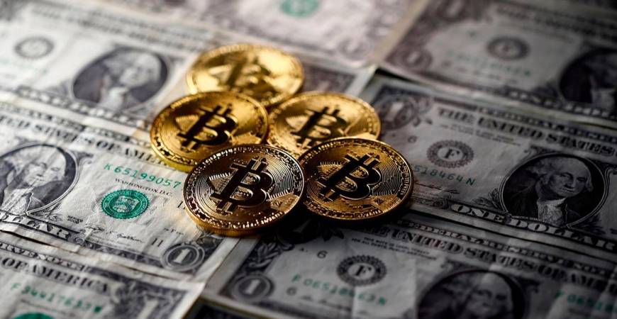FILE PHOTO: Bitcoin (virtual currency) coins placed on Dollar banknotes are seen in this illustration picture, November 6, 2017. REUTERS