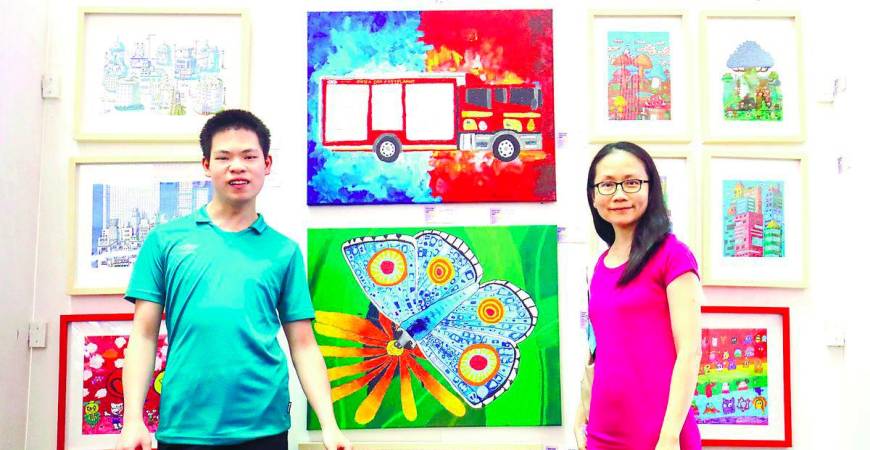 Tay and Sheng at their display booth during the exhibition. – Adib Rawi Yahya/theSun