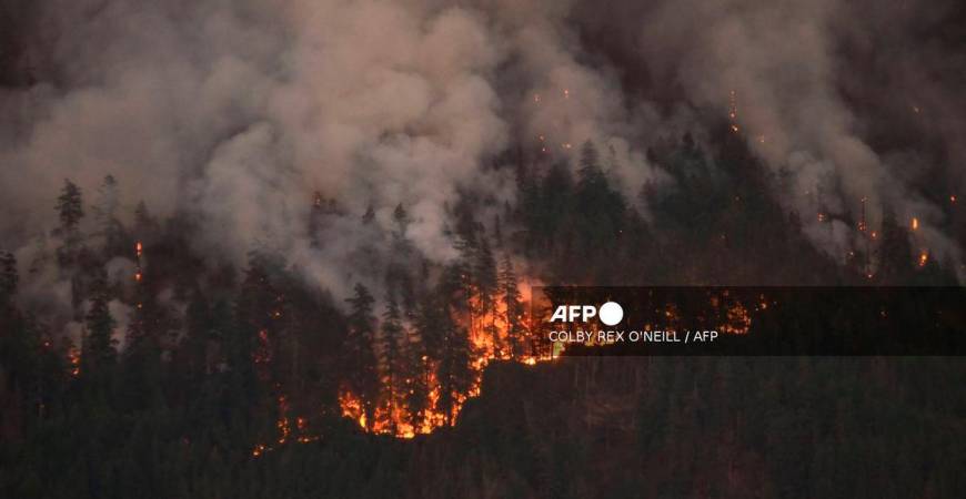A wildfire burns on Mount Underwood near Port Alberni, on Vancouver Island, British Columbia, on August 12, 2025. - AFP