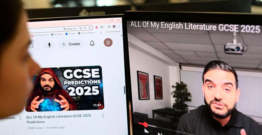 A posed photograph taken as an illustration in London on August 13, 2025 shows a journalist looking at a video by former teacher Waqar Malik on his “Mr Everything English” channel. AFPPix