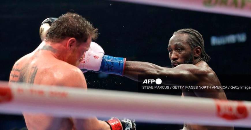 Terence Crawford (R) lands a left on Canelo Alvarez in their undisputed super middleweight title fight during Netflix's Canelo v Crawford Fight Night at Allegiant Stadium on September 13, 2025 in Las Vegas, Nevada. - Getty Images via AFP