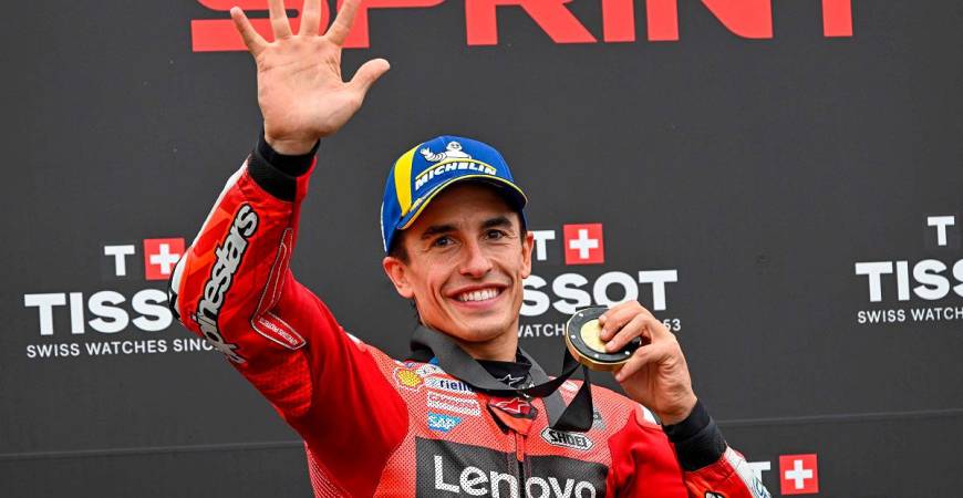 Ducati Lenovo Team’s Spanish rider Marc Marquez celebrates his victory with his gold medal after the sprint race ahead of the motorcycle Hungarian Moto GP Grand Prix at the Balaton Park circuit in Balatonfokajar, Hungary, on August 23, 2025. - ATTILA KISBENEDEK / AFP
