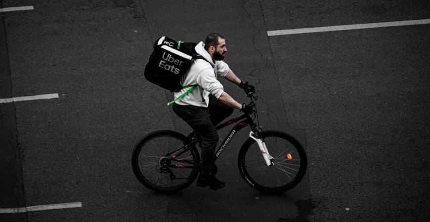 (FILES) In this file photo taken on April 20, 2020 A delivery man working for Uber Eats rides a bicycle in Paris, on the thirty-fifth day of a lockdown in France aimed at curbing the spread of the COVID-19 disease, caused by the novel coronavirus. AFP / Philippe LOPEZ