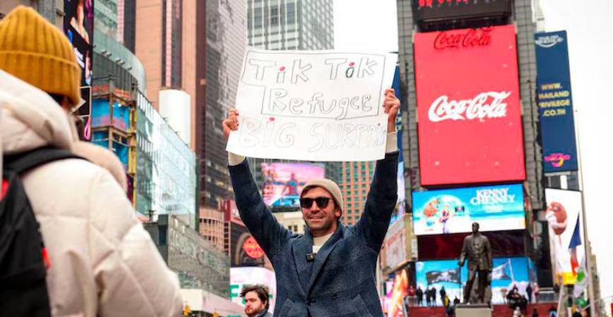 A social media influencer films a video for his new Xiaohongshu, also known as RedNote, after leaving TikTok, in Times Square in New York City - REUTERSpix