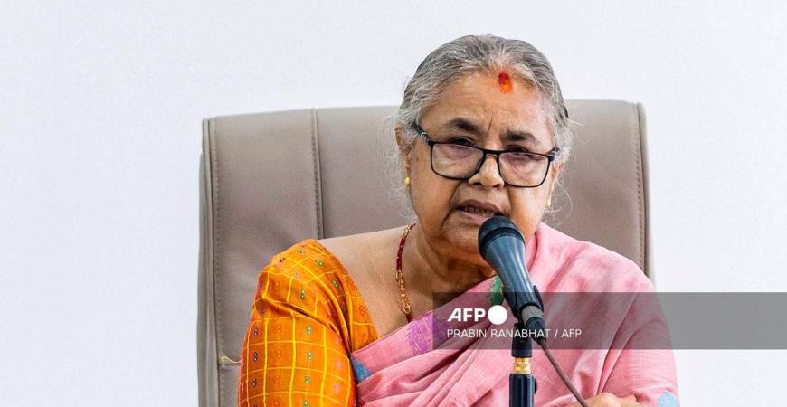 Newly-elected Prime Minister of Nepal’s interim government Sushila Karki speaks with officials at the prime minister’s office in Kathmandu on September 14, 2025. (Photo by PRABIN RANABHAT / AFP)