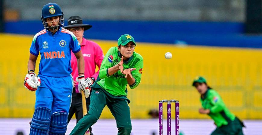 Pakistan’s Rameen Shamim (R) collects the ball as India’s Pratika Rawal watches during the ICC Women’s Cricket World Cup 2025. - S. KODIKARA / AFP