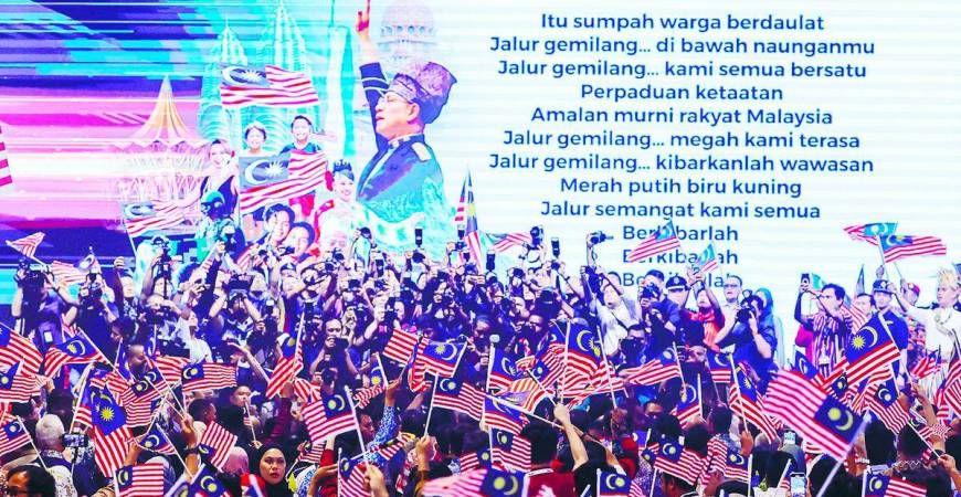 The act of waving the flag expresses a collective heartbeat of unity. – BERNAMAPIC