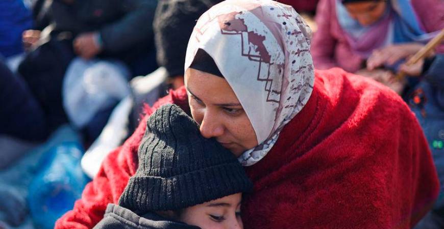 A woman embraces a child as Palestinians wait to be allowed to return to their homes in northern Gaza - REUTERSpix