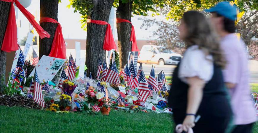People walk by a memorial for U.S. right-wing activist and commentator Charlie Kirk, an ally of U.S. President Donald Trump, who was fatally shot during an event at Utah Valley University, as faculty return to campus ahead of classes starting Wednesday, in Orem, Utah, U.S., September 15, 2025. REUTERS/Jim Urquhart/File Photo