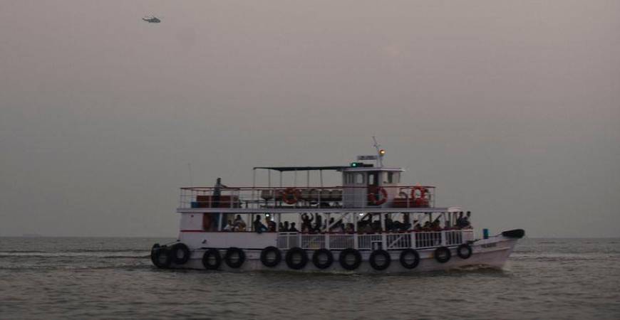 A military helicopter flies over a ferry during a rescue operation after a passenger boat capsized off the coast of India’s financial capital Mumbai - REUTERS/Stringer