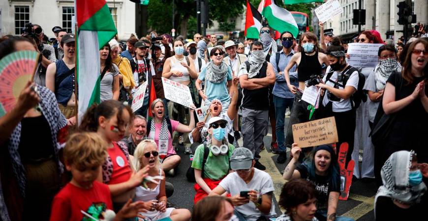 Protestors shout slogans and wave Palestinian flags as they rally in support of pro-Palestinian group Palestine Action after British government announced the group’s ban, in Trafalgar Square, in central London, on June 23, 2025. (Photo by HENRY NICHOLLS / AFP)
