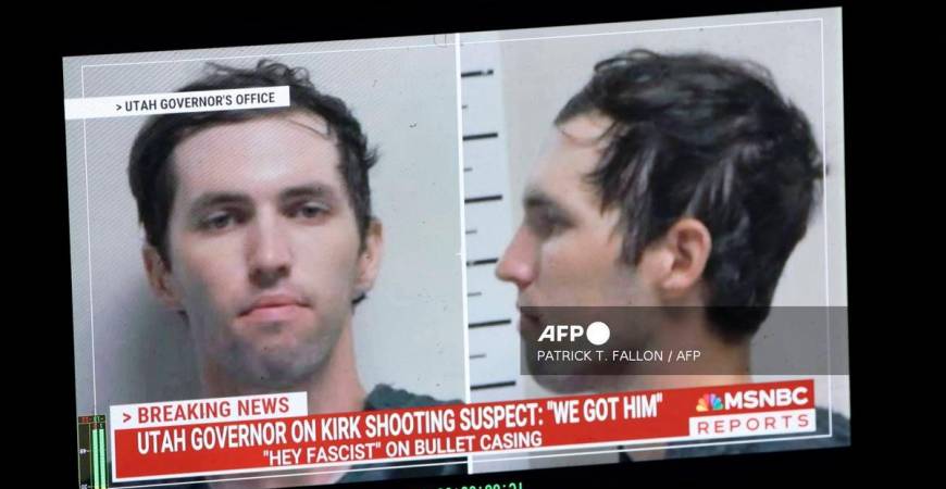 A TV monitor displays a picture of Tyler Robinson, the suspected of killing Charlie Kirk on September 11, in Orem, Utah, on September 12, 2025. (Photo by Patrick T. Fallon / AFP)
