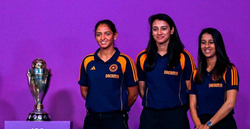 Indian team players Jemimah Rodrigues (R), Smriti Mandhana (C) and Harmanpreet Kaur pose with the trophy during an event held to mark 50 days countdown to the 2025 ICC Women’s Cricket World Cup in Mumbai on August 11, 2025. (Photo by Punit PARANJPE / AFP)