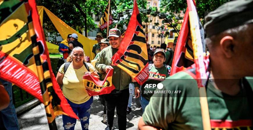 Members of Venezuelan Popular Unity (Unidad Popular Venezolana-UPV) take part in the national enlistment campaign called by the government of President Nicolas Maduro at Bolivar square in Caracas, on August 23, 2025. - AFP