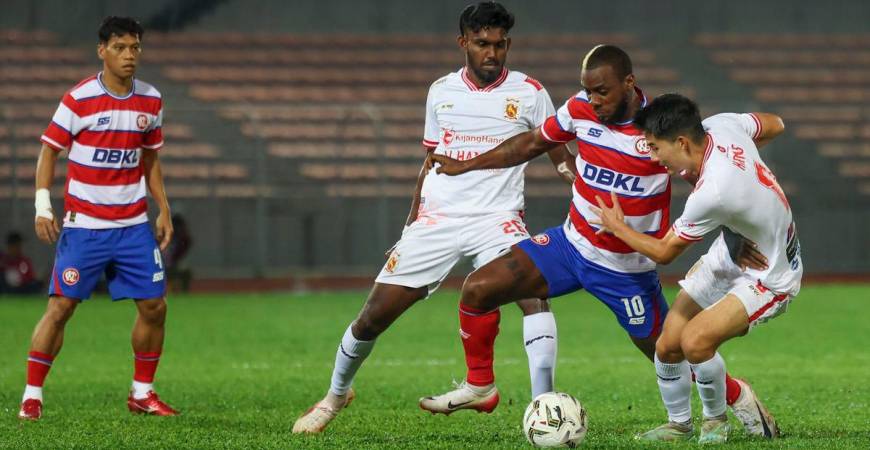 Kuala Lumpur City FC player Kpah Sherman (second from right) is challenged by two players from Kelantan The Real Warriors FC during the 2025/2026 FA Cup match at the Kuala Lumpur Football Stadium last night. - BERNAMA