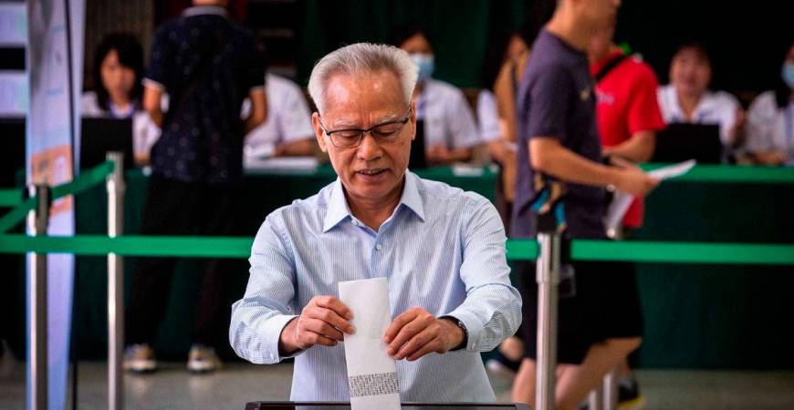 Macau’s Chief Executive Sam Hou-fai casts his vote at the Salesian Institute of the Immaculate Conception polling station during the Legislative Assembly election in Macau on September 14, 2025. (Photo by Eduardo Leal / AFP)
