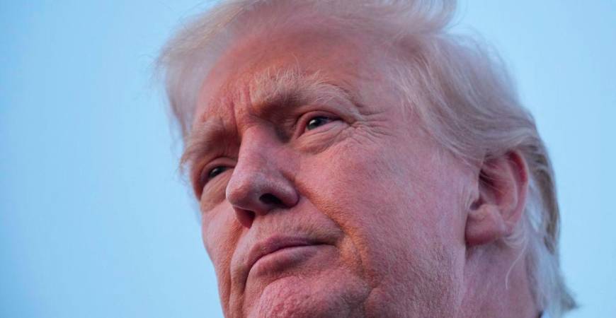 U.S. President Donald Trump looks on as he talks to members of the press at Lehigh Valley International Airport in Allentown, Pennsylvania, U.S., August 3, 2025. REUTERS/Ken Cedeno