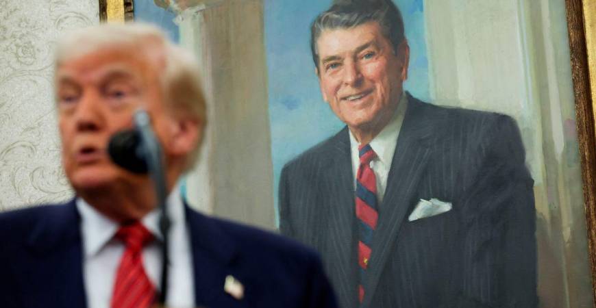 A portrait of former U.S. President Ronald Reagan is seen in the background as U.S. President Donald Trump speaks during a swearing-in ceremony for the new U.S. ambassador to China, former U.S. Senator David Perdue, at the White House in Washington, D.C., U.S., May 7, 2025. REUTERSpix