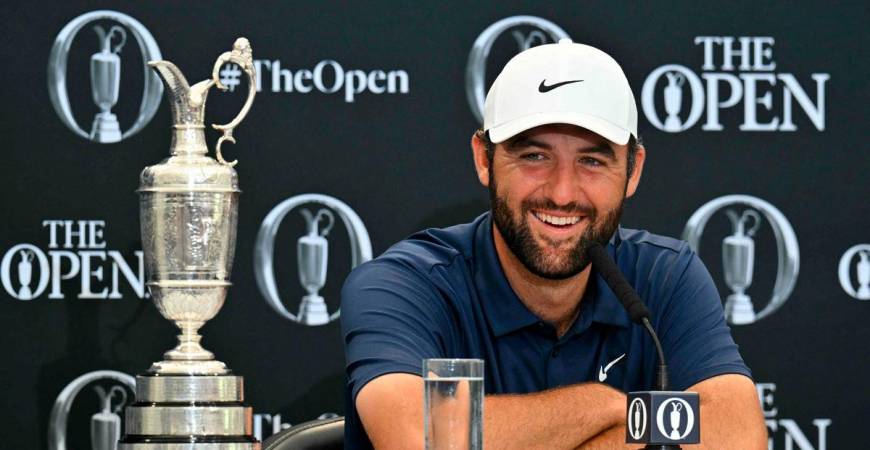 US golfer Scottie Scheffler with the Claret Jug, the trophy for the Champion golfer of the year beside him, holds a press conference after his victory in the 153rd Open Championship at Royal Portrush golf club in Northern Ireland on July 20, 2025 - AFP