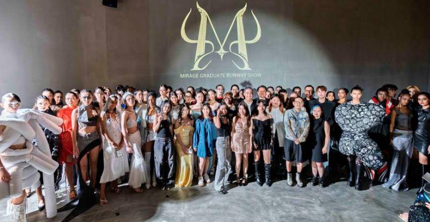 The aspiring fashion designers posing at their graduation show at the Gray Box