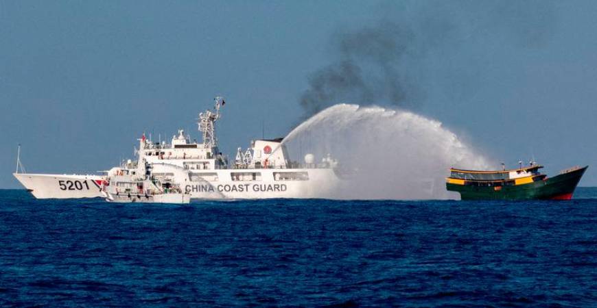 Chinese Coast Guard vessels fire water cannons towards a Philippine resupply vessel Unaizah May 4 on its way to a resupply mission at Second Thomas Shoal in the South China Sea - REUTERSpix