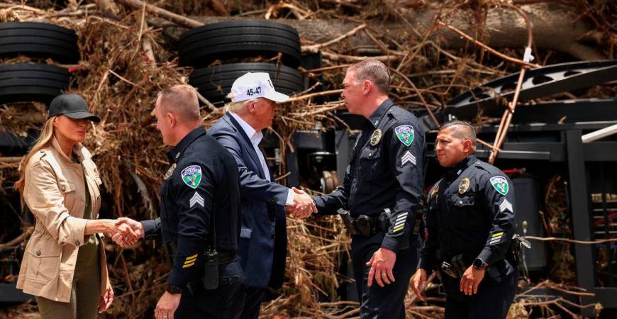 U.S. President Donald Trump and first lady Melania Trump shake hands with Kerrville police officers, as they visit a scene of devastation along the banks of the Guadalupe River, after catastrophic floods, in Kerr County, Texas, U.S., July 11, 2025. REUTERS