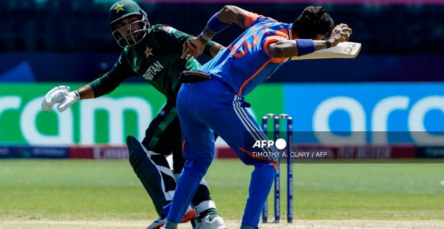 India's Hardik Pandya (R) tries to throw the ball past Pakistan's Usman Khan during the ICC men's Twenty20 World Cup 2024 group A cricket match between India and Pakistan at Nassau County International Cricket Stadium in East Meadow, New York on June 9, 2024. - TIMOTHY A. CLARY / AFP