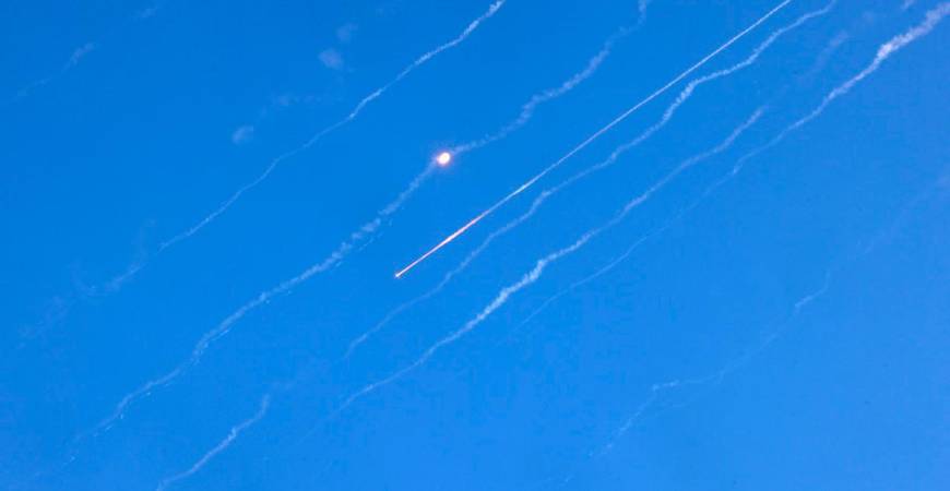 Missiles fired from Iran are pictured over Hebron in the occupied West Bank on June 19, 2025. Israel’s foreign ministry reported a direct hit on a hospital in the south on June 19, after Iran fired a fresh salvo of missiles at the country. - HAZEM BADER / AFP