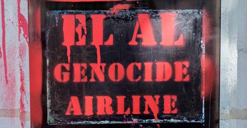 A slogan sprayed with red paint on the entrance of the El Al Israel Airlines offices in Paris on August 7, 2025. (Photo by STEPHANE DE SAKUTIN / AFP)