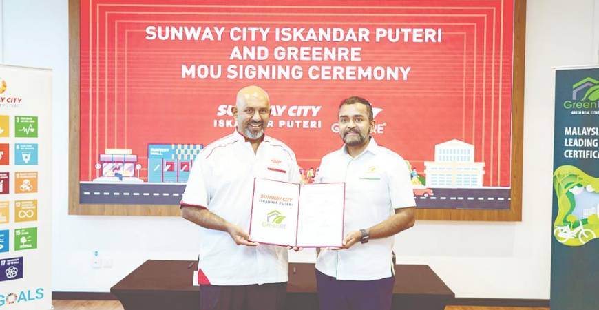 Gerard (left) and GreenRE executive director Ashwin Thurairajah formalising the partnership at the MoU-signing event.