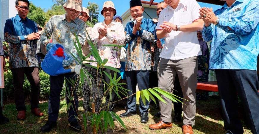 Chan (second, left) watering a bamboo plant to mark the opening of World Bamboo Day Malaysia 2025 at the Bamboo Model Farm, Terengganu Timber Industry Training Centre in Kuala Berang. – Bernamapic