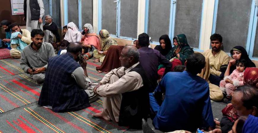 Passengers, who were rescued from a train after it was attacked by separatist militants, sit at the Mach Railway Station in Mach, Balochistan - REUTERSpix