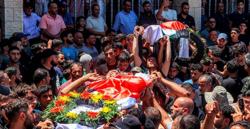 Mourners carry the bodies of dual US-Palestinian citizen Saif al-Din Kamil Abdul Karim Musalat and Palestinian Mohammad al-Shalabi during their funeral at the Palestinian village of Al-Mazraa Al-Sharqiya in the occupied West Bank on July 13, 2025, after they were reportedly killed by Israeli settlers two days prior. - Zain JAAFAR / AFP