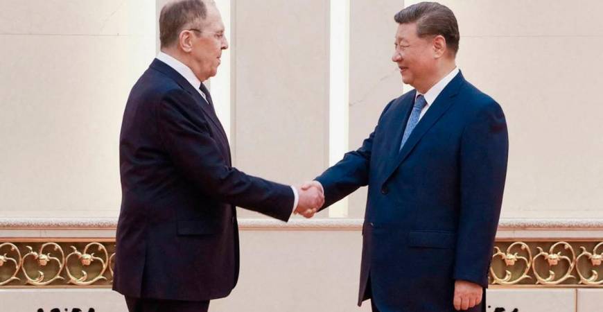 This handout photograph released by the Russian Foreign Ministry shows China’s President Xi Jinping (R) shaking hands with Russian Foreign Minister Sergey Lavrov in Beijing on July 15, 2025. - AFP PHOTO / HANDOUT / RUSSIAN FOREIGN MINISTRY
