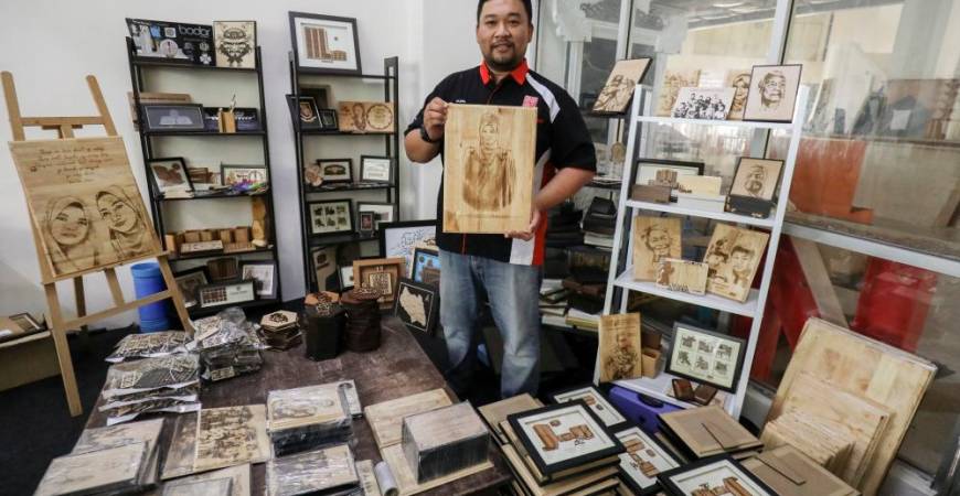 Ahmad Fazrin Abdul Rahman, the founder of Rinacraft, with his woodcraft merchandise. – HAFIZ SOHAIMI/THESUN