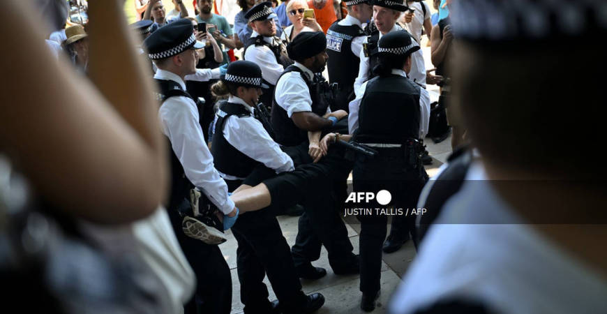 A protester is carried away after being arrested as people gather in support of the pro-palestinian group “Palestine Action”, in Parliament Square, London on July 12, 2025, following the Home Secretary’s decision to proscribe the group under anti-terror laws. - AFP