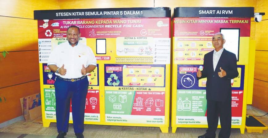 From left: Ramli and HMA Digital chairman Datuk Baharon Talib in front of the AI-powered Smart 5-in-1 Reverse Vending Machine.