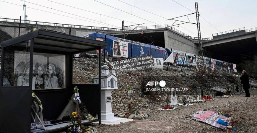 A man pays respect to the victims at the crash site to mark two years since the “national trauma” of the train crash on 28 February 2023 which killed 57 people, mostly students, and injured dozens, in the valley of Tempi, near Larissa, on February 27, 2025. (Photo by Sakis Mitrolidis / AFP)