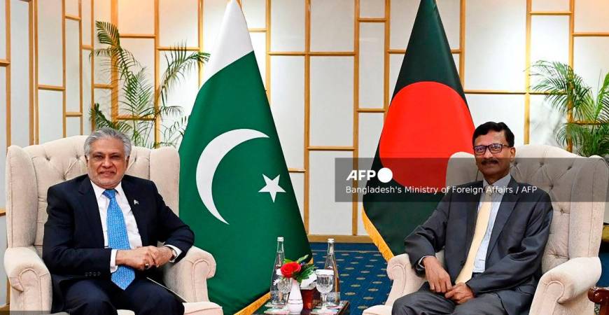 Foreign Affairs Advisor of Bangladesh’s interim government Mohammad Touhid Hossain (R) posing alongside Pakistan’s Foreign Minister Ishaq Dar during a bilateral meeting in Dhaka. - (Photo by Bangladesh’s Ministry of Foreign Affairs / AFP)